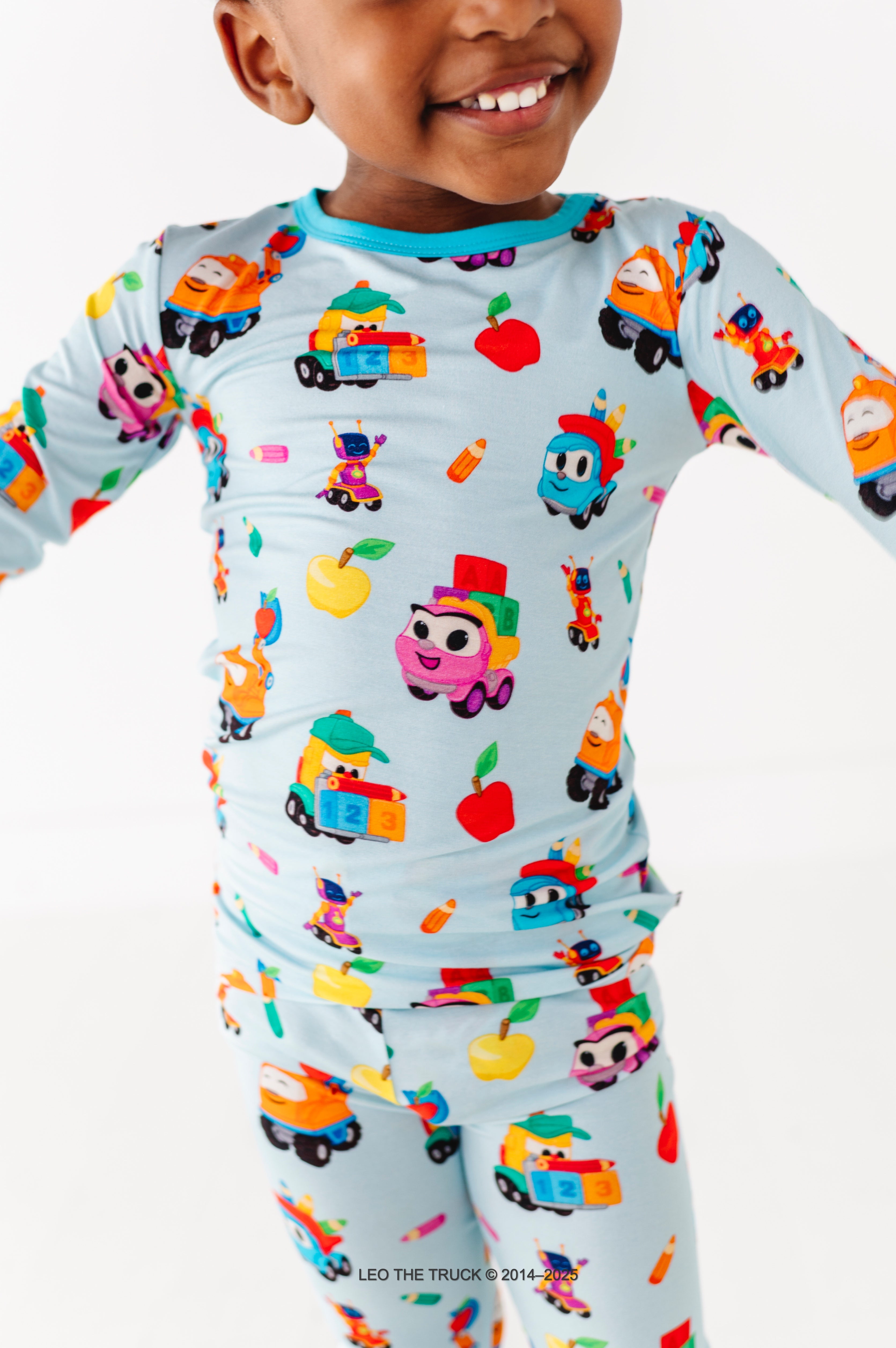 Close-up shot of Leo the Truck bamboo pajamas on a little boy against a white background
